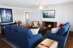 a living room with two blue couches and a fireplace at 1400 South Bayfront in Newport Beach