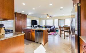 a kitchen with an island and a living room at 209 38th St. B Condo in Newport Beach
