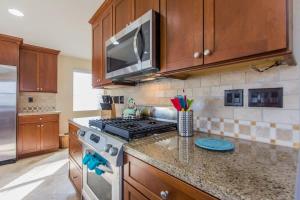 a kitchen with a stove and a microwave at 209 38th St. B Condo in Newport Beach +34 photos