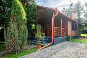 a house with a red hose in front of it at Bodony Cottage in Bodony