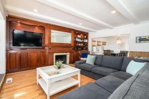 a living room with a couch and a tv at 1002 East Oceanfront in Newport Beach