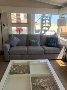 a living room with a couch and a glass table at 1002 East Oceanfront in Newport Beach