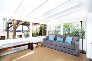 a living room with a couch and a large window at 1002 East Oceanfront in Newport Beach