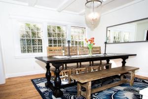 a dining room with a table and benches at 1002 East Oceanfront in Newport Beach +55 photos