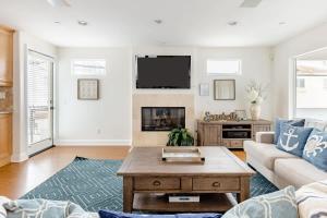 a living room with a couch and a coffee table at Iris Condo 213 Condo in Corona del Mar
