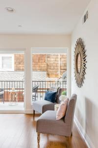 a living room with two couches and a balcony at Iris Condo 213 Condo in Corona del Mar