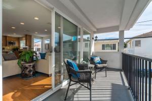 a porch with chairs and a couch on a balcony at Iris Condo 213 Condo in Corona del Mar +46 photos