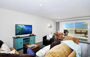 a living room with a couch and a flat screen tv at 1005 E Balboa Unit A Lower #1 in Newport Beach