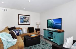 a living room with a couch and a flat screen tv at 1005 E Balboa Unit A Lower #1 in Newport Beach