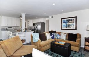 a living room with two couches and a kitchen at 1005 E Balboa Unit A Lower #1 in Newport Beach