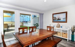 a dining room with a table and a view of the ocean at 1005 E Balboa Unit A Lower #1 in Newport Beach