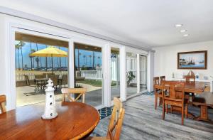 a living room with a table and a dining room with the ocean at 1005 E Balboa Unit A Lower #1 in Newport Beach +31 photos