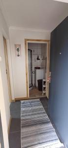a room with a hallway with a rug on the floor at Pod Górą in Wiśniowa +43 photos