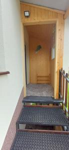 a room with a door with a bench in it at Pod Górą in Wiśniowa