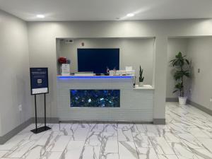 an office lobby with a fireplace with a tv at Micro Hotel in Conyers