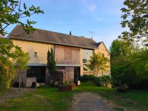 a large brick building with a yard in front of it at La Motelle N 5 in Les Ulmes