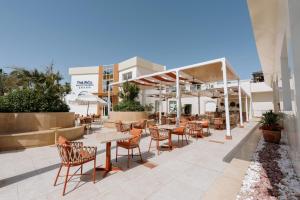 a patio with tables and chairs in a restaurant at TheLifeCo Sharm El Sheikh in Sharm El Sheikh