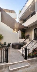 a swimming pool on the side of a house at West of Preveza Luxury Jacuzzi Apartment in Preveza