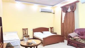 a room with two beds and a table and a couch at Garden EVN Airport 5 min from Airport in Pʼarakʼar