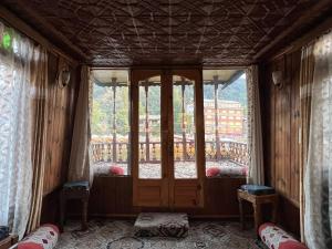a room with a door and a window with a balcony at FREEDOM houseBoat in Srinagar