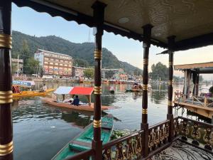 a boat on the water in a river at FREEDOM houseBoat in Srinagar