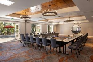 a large banquet room with a long table and chairs at River Terrace Inn in Napa