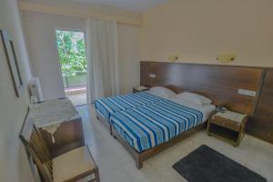 Postel nebo postele na pokoji v ubytování Hotel Achillion