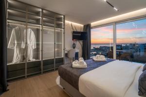 a hotel room with a large bed and a large window at Dedaj Resort - Penthouse Auri in Zadar +48 photos