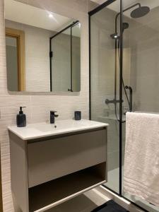 a bathroom with a sink and a glass shower at Hilton Tanger View Tower 15D in Tangier +20 photos
