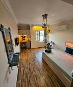 a bedroom with a bed and wooden floors in a room at Deluxe Apartment Delta Sharm in Sharm El Sheikh +62 photos