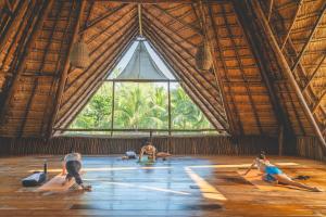 a group of people doing yoga in a large room at Cabanas Tulum- Beach Hotel & Spa in Tulum