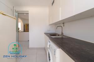a white kitchen with a sink and a dishwasher at Villa Reyets 4 bed 3 bath Private Pool in Busot