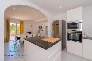 a kitchen with a counter top and a dining room at Villa Reyets 4 bed 3 bath Private Pool in Busot