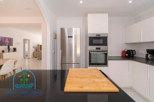 a kitchen with a table with a sign that says learn holiday at Villa Reyets 4 bed 3 bath Private Pool in Busot