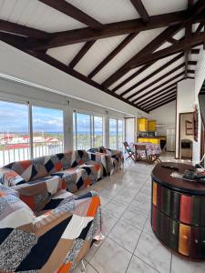a large living room with couches and a table at Le Chalet in Saint-François