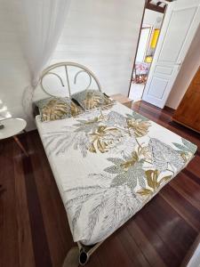 a bed in a room with a blanket on it at Le Chalet in Saint-François +23 photos