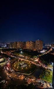 a city at night with a lot of traffic at Skyline suites in Noida +1 photo