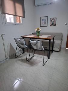 a table and two chairs in a room with a bed at Titi's home 2 in Ofrínion