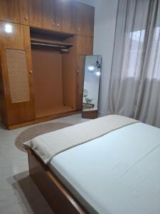 a bedroom with a bed and a dresser and a mirror at Titi's home 2 in Ofrínion