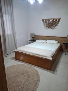 a bedroom with a large bed with white sheets at Titi's home 2 in Ofrínion