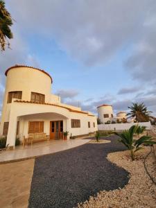 a large white building with two silos at Casa 13 - Refúgio Salinas in Vila do Porto