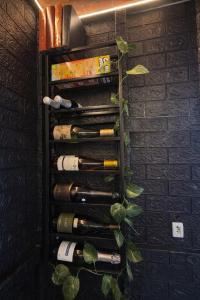 a wine rack filled with bottles of wine at Lumos Experience in Guaratuba