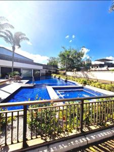 a swimming pool on a balcony with a fence at Flat das Montanhas in Rio de Janeiro