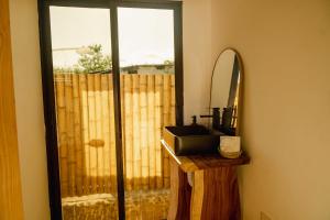 a bathroom with a sink and a mirror at Alma Vita Punta Mango in Jucuarán