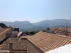 a group of roofs with mountains in the background at B&B Belvedere in Monreale