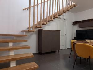 a living room with a staircase and a table with chairs at B&B Belvedere in Monreale