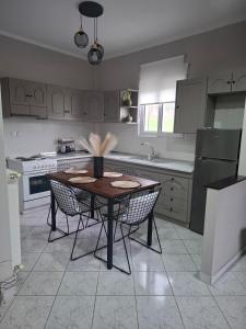 a kitchen with a wooden table and chairs in it at Titi's home in Ofrínion