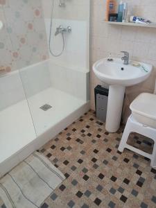 a bathroom with a sink and a shower and a toilet at tamzain24 in Marseille