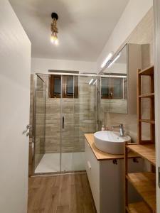 a bathroom with a glass shower and a sink at Casa Gemelli in San Fedele Intelvi +47 photos