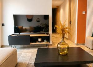 a living room with a vase on a table at Maarif appartement moderne in Casablanca